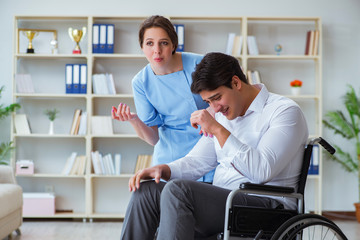 Disabled patient on wheelchair visiting doctor for regular check