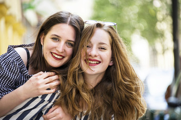 Obraz premium Two lovely girls having fun on the street. Bff conception. 