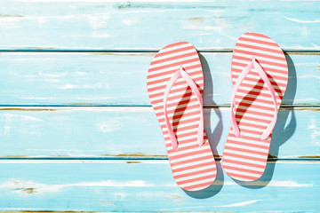 Pink Beach flip flop on white wooden floor