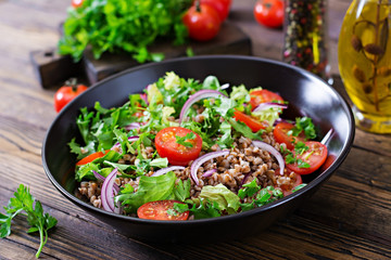 Buckwheat salad with cherry tomatoes, red onion and fresh herbs. Vegan food. Diet menu.