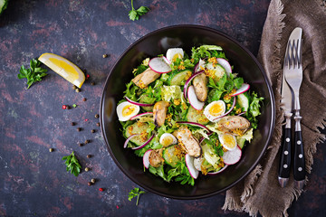 Dietary salad with mussels, quail eggs, cucumbers, radish and lettuce. Healthy food. Seafood salad. Top view. Flat lay.