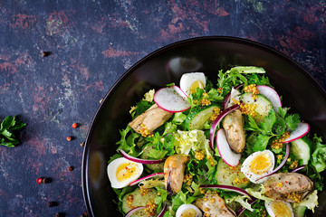 Dietary salad with mussels, quail eggs, cucumbers, radish and lettuce. Healthy food. Seafood salad. Top view. Flat lay.