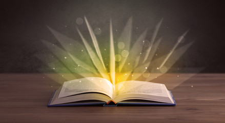 Yellow lights spreading from an open book 