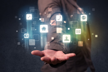 Blue social application icons in the hands of young casual businesswoman