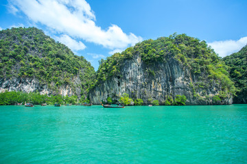 Longtail boats anchored near the big mountain at the Hong Island in Krabi Province Thailand