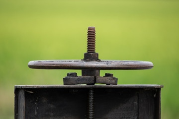 Iron wheel that opens a floodgate to  the water in the rice paddies of Thailand.