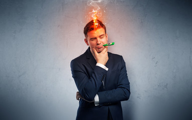 Fever businessman with burning head concept
