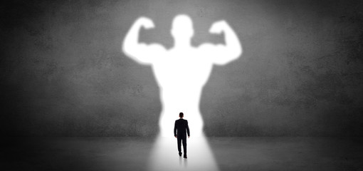 Businessman standing and dreaming about a strong superhero