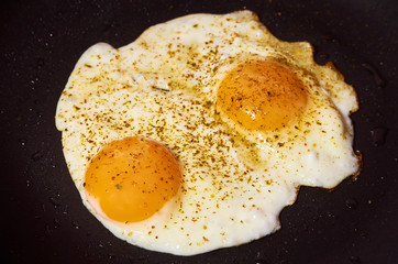 Fried egg on fry pan background. Home made fast food