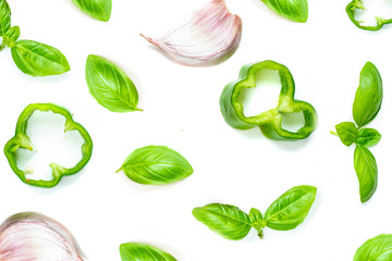 Creative food pattern with Fresh vegetables, herbs and spices isolated on white background.  Flat lay. Healthy food background basil leaves, garlic, green pepper. Close up.