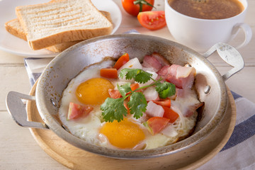 Breakfast including coffee, Egg pan, bread,