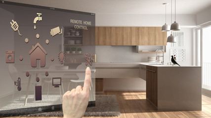 Smart home control concept, hand controlling digital interface from mobile app. Blurred background showing modern kitchen, architecture interior design