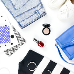 Casual style woman clothes and fashion accessories flat lay. Trendy patterns and prints concept. Top view