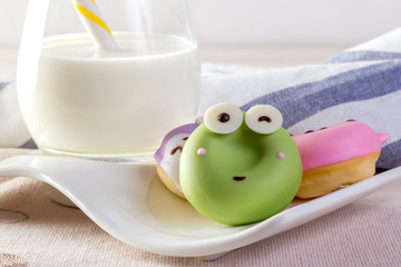 Sweet cartoon donut with milk for kids.