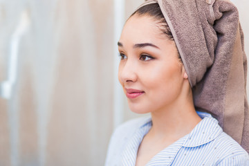 Spa woman towel on head looking to the side with a smile, copyspace, beauty face, care