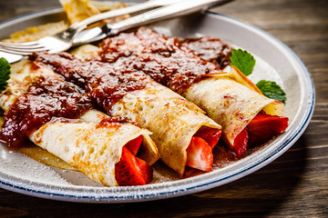 Pancakes with cream and strawberries