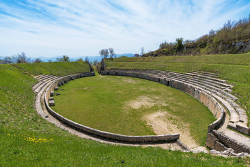 Alba Fucens (Italy) - An evocative Roman archaeological site with amphitheater and ruins of medieval castle, in a public park in front of Monte Velino mountain with snow, Abruzzo region, central Italy