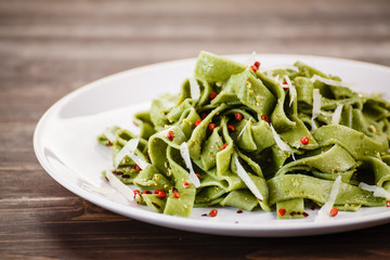 Pasta with cheese on wooden table