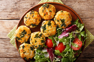chicken balls with spinach and a salad of fresh vegetables close-up. Horizontal top view