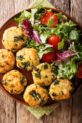 Dietary tasty meat balls with spinach and vegetable salad close-up. Vertical top view