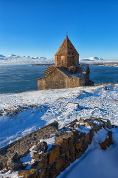 Scenic view of an old Sevanavank church in Sevan, Armenia on sunny winter day blue sky