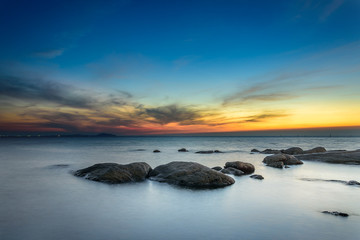 Fototapeta na wymiar Rocks at sea side with sunset sky