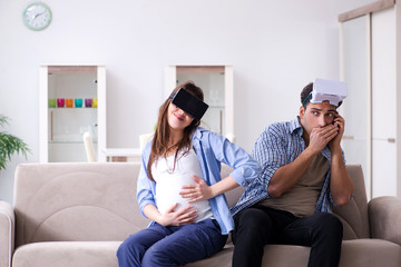 Young couple trying virtual reality glasses goggles
