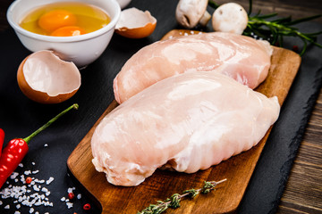 Raw chicken fillet on wooden table