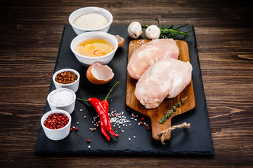Raw chicken fillet on wooden table