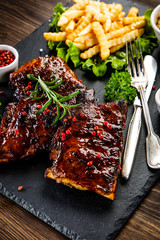 Grilled ribs, french fries and vegetables