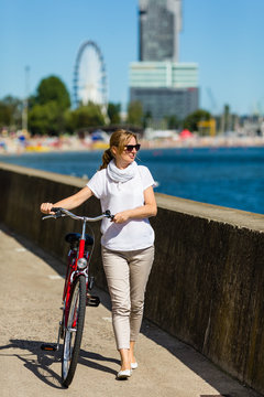 Woman and bike on pier