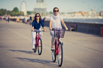 Women biking on pier