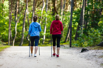 Nordic walking - active people working out in park