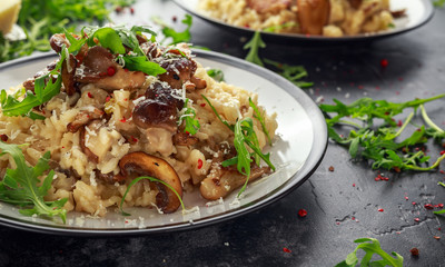 Italian Mushroom risotto with parmesan cheese and wild rocket on top.