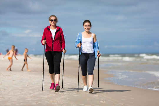 Nordic walking - two women training on beach