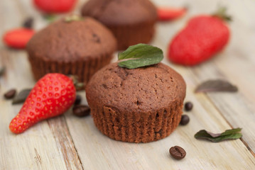 Chocolate Muffins with Strawberry Mint Leaves over rustic Gray Background Breakfast desert