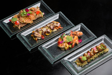 Different appetizer and anti pasti. Sea food platter Tapas and bites food concept. Shrimp, octopus, crab