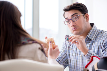 Woman visiting jeweler for jewelery evaluation