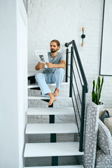 Man Reading Newspaper At Home