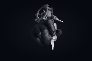 Master of tattoo process holds an induction machine for drawing in black gloves, dark background.