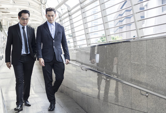 two business talking with partner about business and invetment  on way to office