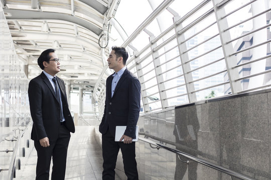 two business talking with partner about business and invetment  on way to office