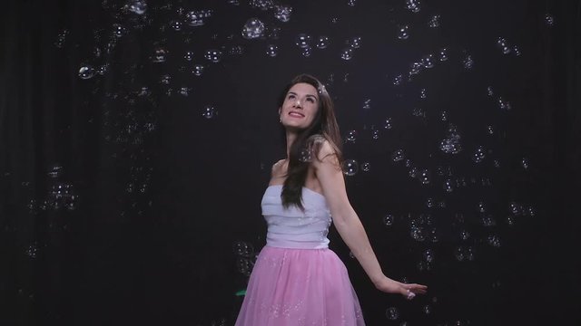 Woman among soap bubbles
