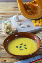 Pumpkin soup on a wooden table