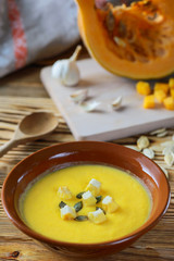 Cream soup of pumpkin on a wooden table