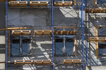 Fragment of a building facade with scaffolding. The picture was taken in Russia, in the city of Orenburg