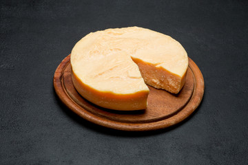 Whole round Head and pieces of parmesan or parmigiano