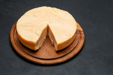 Whole round Head and pieces of parmesan or parmigiano