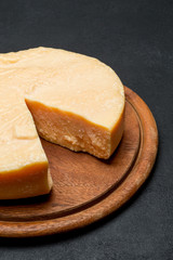 Whole round Head and pieces of parmesan or parmigiano