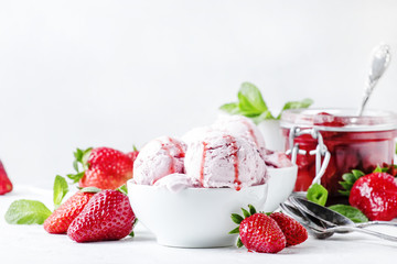 Strawberry ice cream with topping, decorated with mint leaves, white background, high key,...